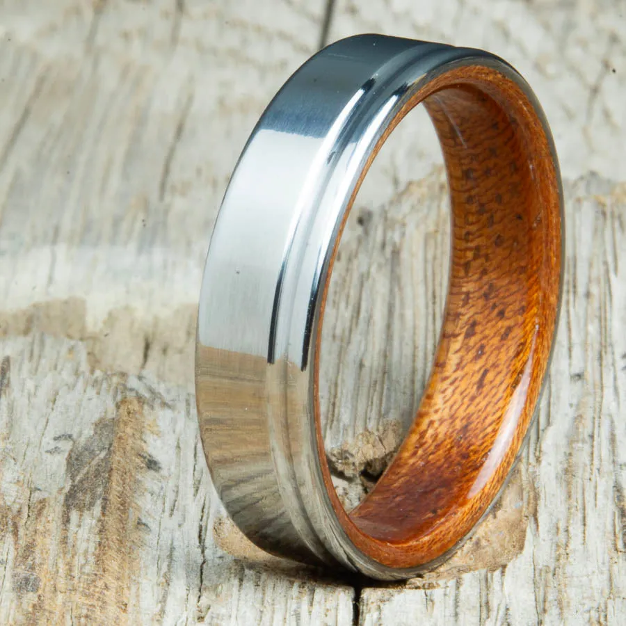 Polished titanium wedding band with Acacia interior